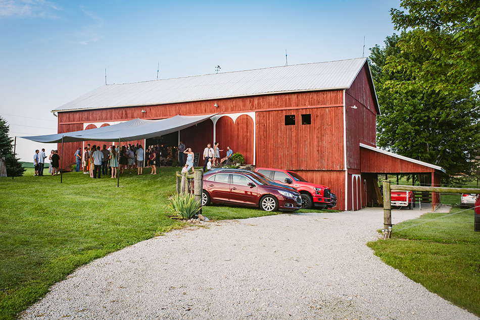 Rustic barn reception venue set next to a pond, beautifully decorated for the wedding celebration.