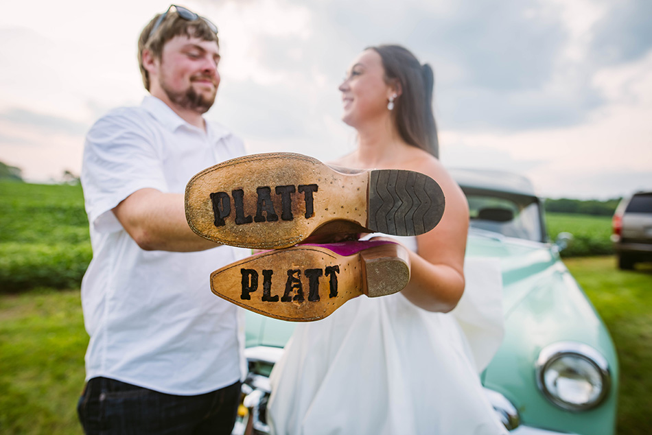 Close-up of branded cowboy boots with the couple's last name, showcasing a unique wedding tradition.