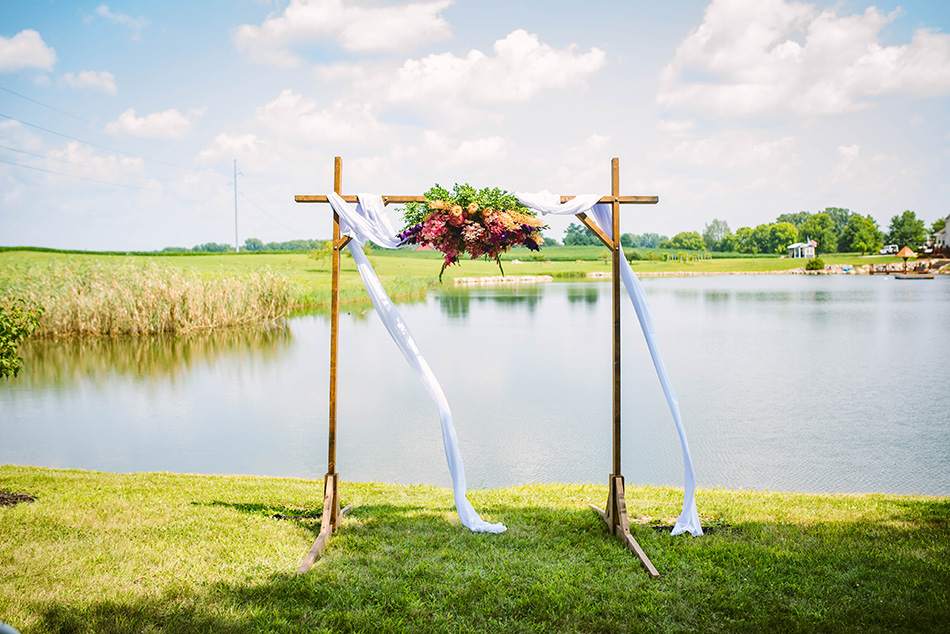 Serene pondside setting of the wedding ceremony, surrounded by nature and loved ones.