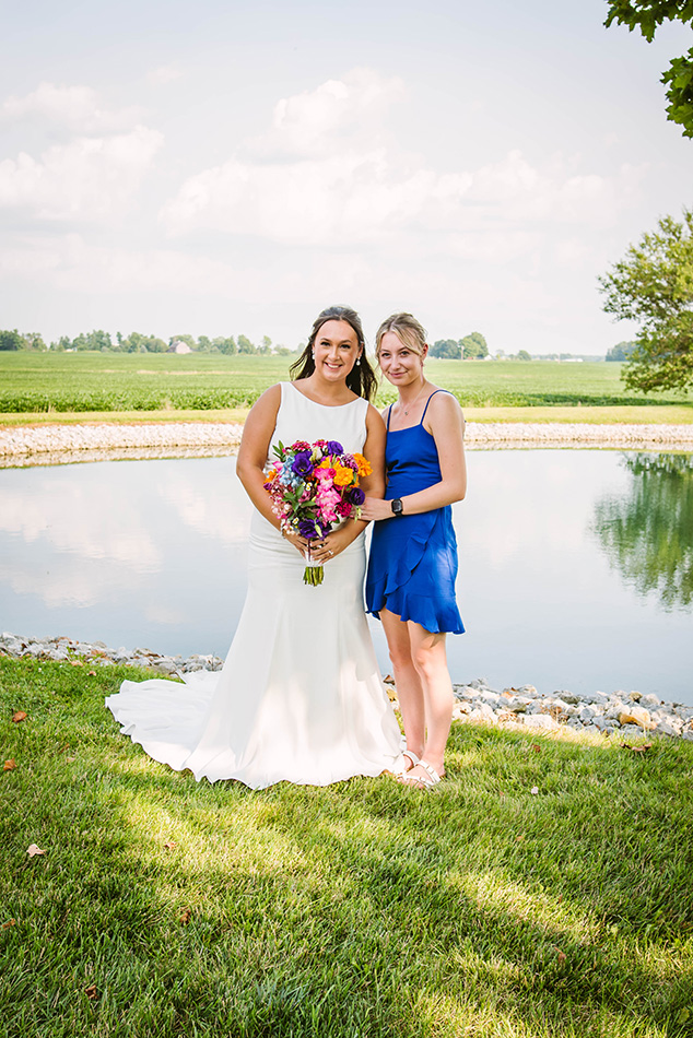 'Something blue' friend dressed in a blue dress and pink heels, organizing and helping run the wedding day smoothly.