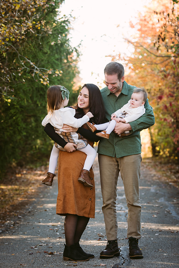Two parents and two children posing for a family portrait