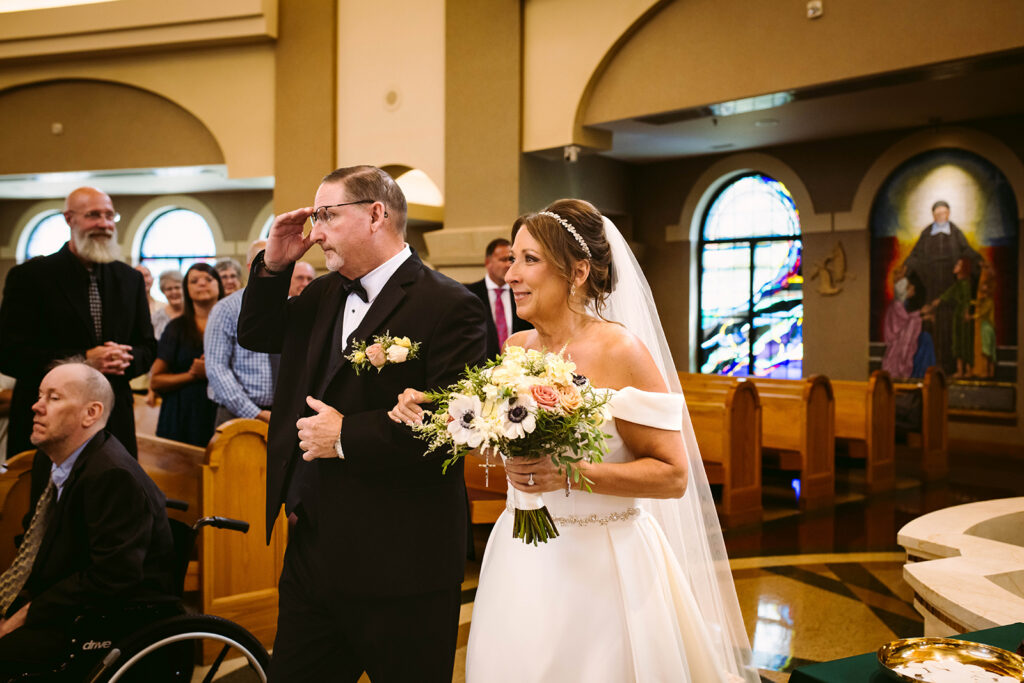 Bride smiling as she walks toward her groom during their Fort Wayne wedding ceremony.